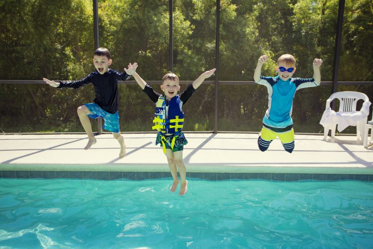 boys jumping into family pool 768x512