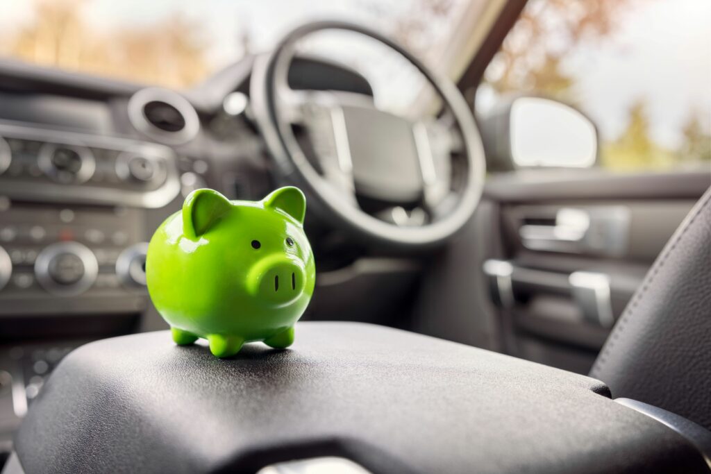 green piggy bank inside car on middle console